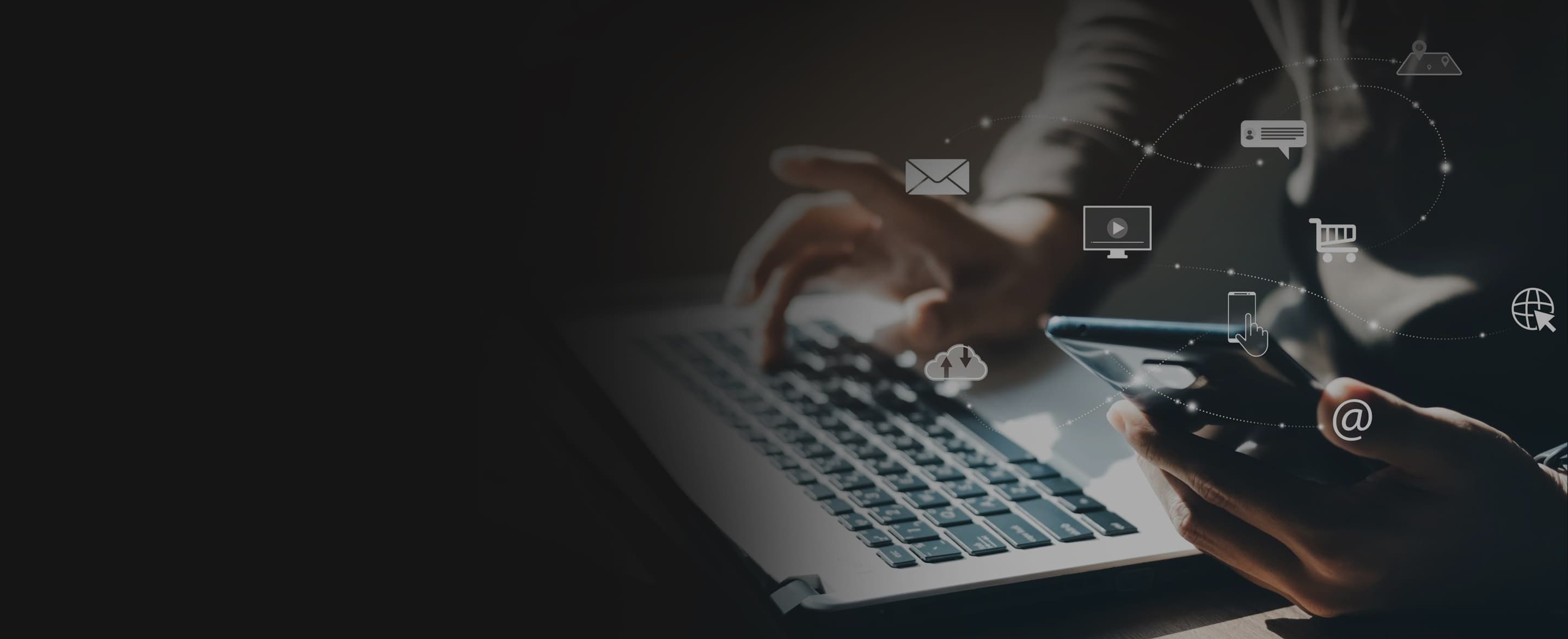 Tangan di atas laptop dan ponsel dengan ikon komunikasi mengambang